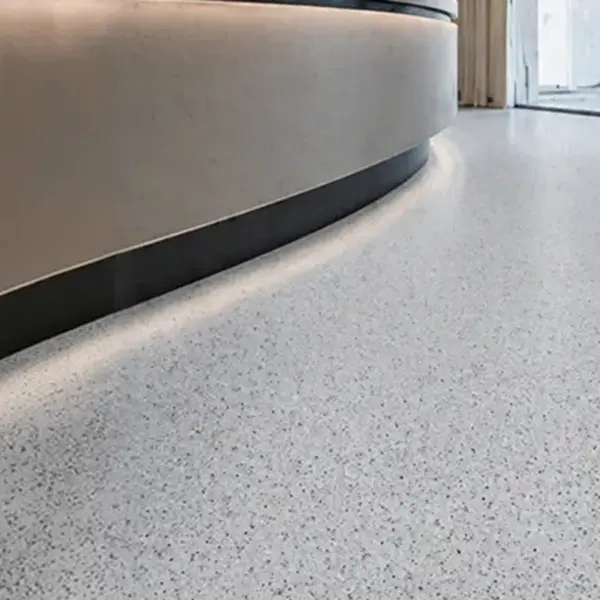 Seamless polymer terrazzo flooring with a light marble-effect textured finish