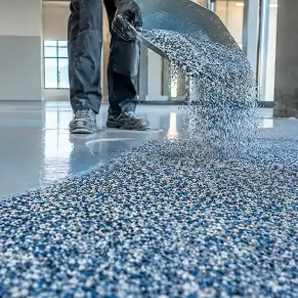 Terrazzo-style floor coating being trowel applied over a prepared floor