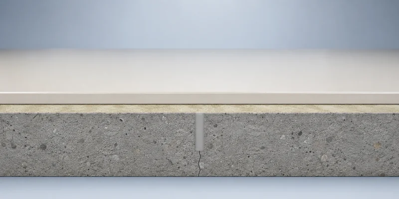 Filled control joint beneath a continuous seamless epoxy flooring system