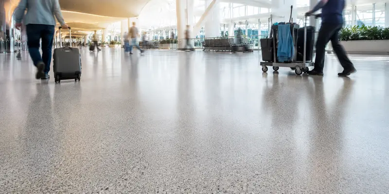 High-traffic resin flooring supporting pedestrian and rolling traffic