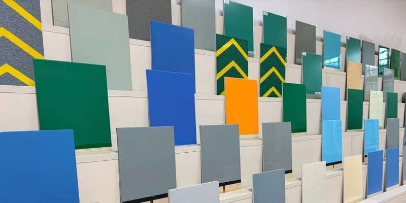 Resin floor coating sample boards with different colors and surface finishes.