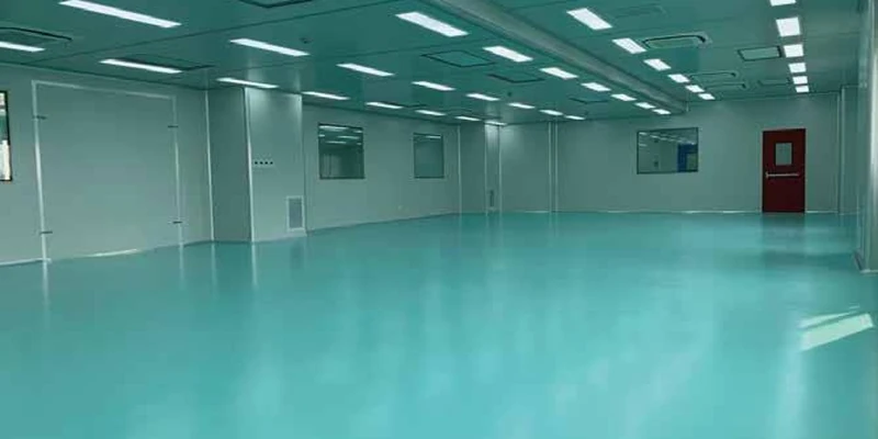 Turquoise resin floor in a clean workshop shown in DIMERY's project brochure.